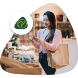ReMade in Australia logo next to customer smiling while inspecting a product in a store