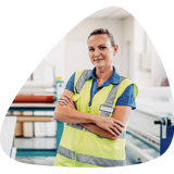 Woman wearing high vis vest standing with arms crossed